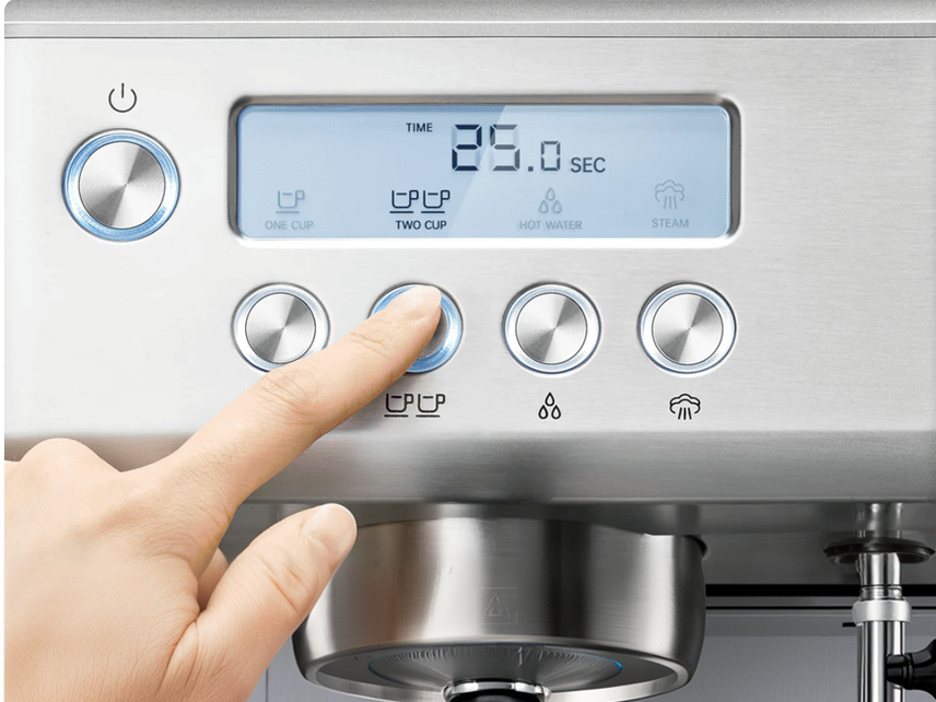 Finger pressing the two-cup button on the espresso machine control panel