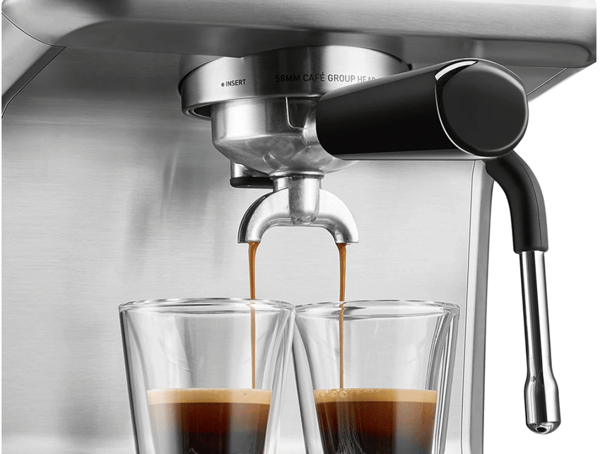 Espresso extracting into two glasses from the portafilter